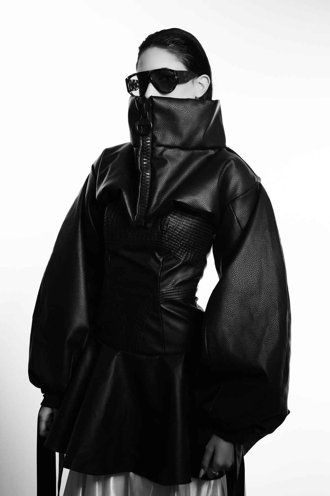 ASPHYXIA: black and white portrait with sunglasses and a zipped high neck